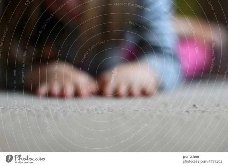 Child playing on the floor. Blurred child hands Lie Carpet Playing blurriness Living or residing Life Crawl