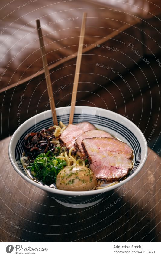 Ramen in bowl with chopsticks on table ramen soup dish tradition oriental meal japanese cuisine delicious tasty serve gastronomy food nutrition gourmet recipe