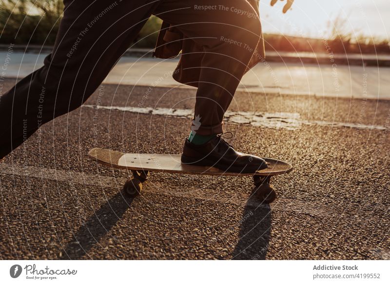 Unrecognizable skater on asphalt road man ride skateboard countryside rural nature hobby subculture practice skill male energy cool motion sport balance move
