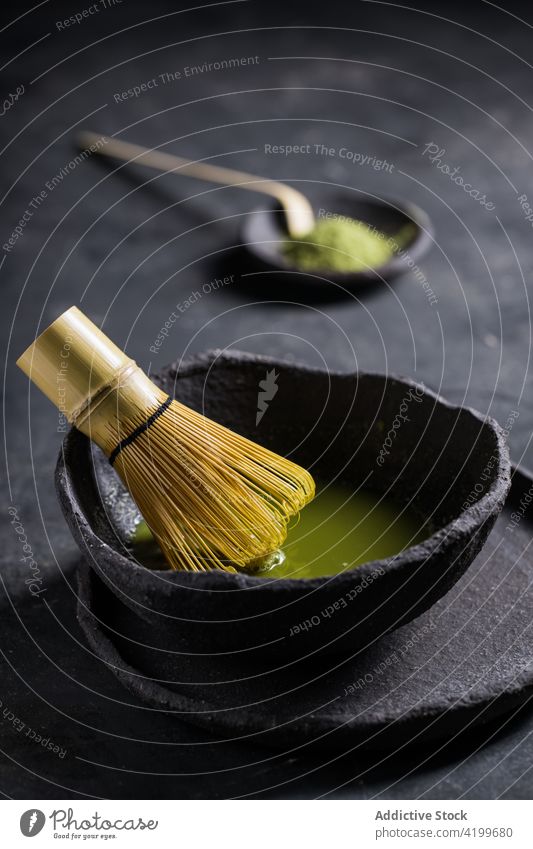Bowl with aromatic matcha tea with chasen whisk bowl oriental teatime culture brew ceremony natural national beverage authentic stone healthy bamboo herbal