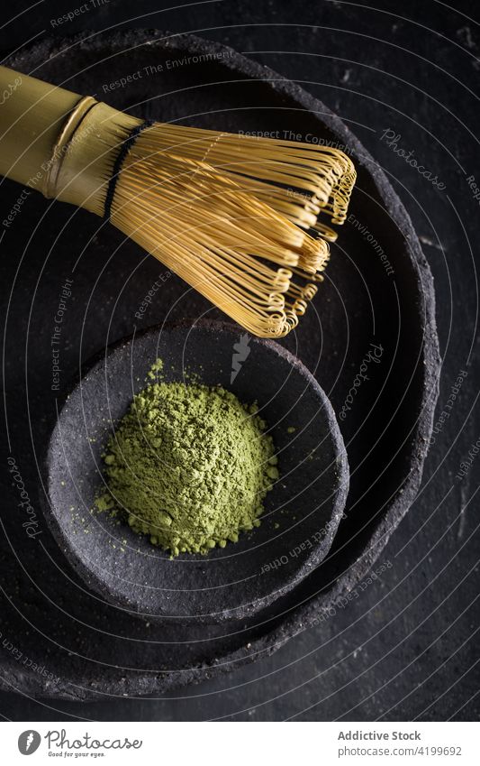 Bamboo tea whisk with powdered matcha on stone plates aroma condiment natural ceremony culture herbal aromatic drink heap dried chasen teatime tasty organic