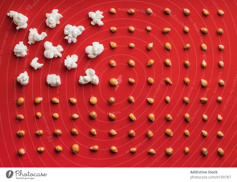 Closeup of some popcorn on a red background top view from above food snack delicious salty white tasty healthy fresh closeup entertainment sweet classic