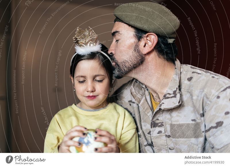 Loving father kissing daughter while saying goodbye before military service soldier army serve together gentle caress man girl male dad child beard close tender