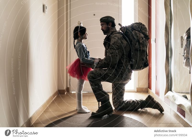 Father saying goodbye to daughter before war campaign father soldier military force combat ammunition warrior defend army man male girl martial farewell protect