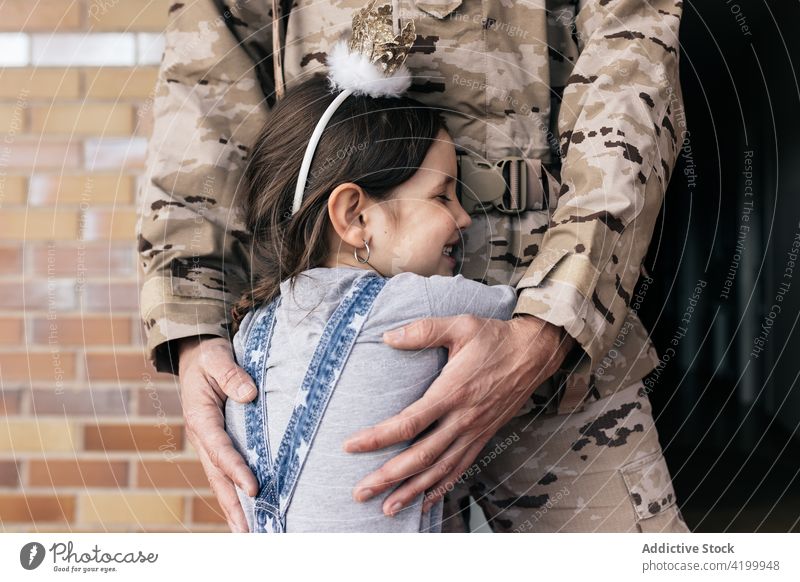 Girl hugging military man after homecoming daughter father wait serviceman soldier arrive love child male kid girl house uniform parent together childhood