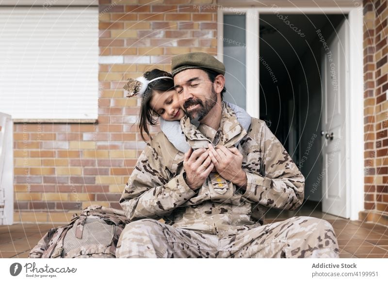 Girl hugging military man after homecoming daughter father wait serviceman soldier arrive love child male kid girl house uniform parent together childhood