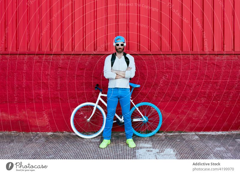 Man standing with bicycle on the street man rider cyclist style trendy city male masculine hobby modern bike casual urban town summer activity hipster rest