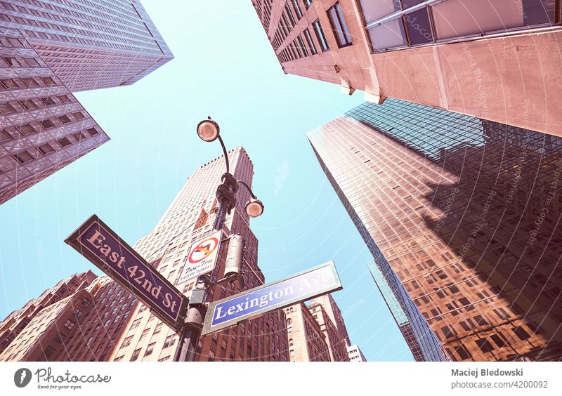 Looking up at Lexington Avenue and East 42nd Street signs in Manhattan, color toned picture, New York City, USA. city look up street skyscraper NYC filtered