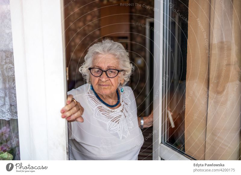 Portrait of an elderly woman at her home eople senior mature casual female Caucasian house old aging domestic life grandmother pensioner grandparent retired