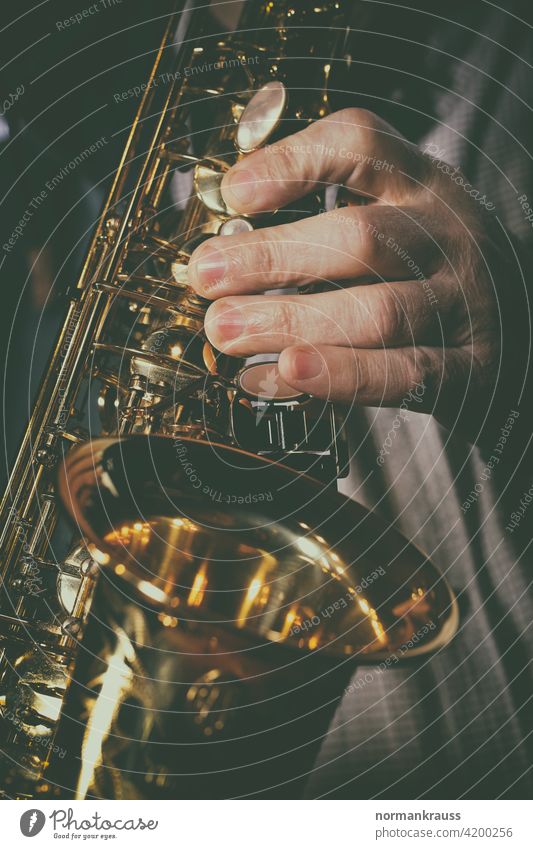 Saxophone and musician Hand Fingers Musical instrument wind instrument tool Musician splendour Gold Brass Woodwind instrument
