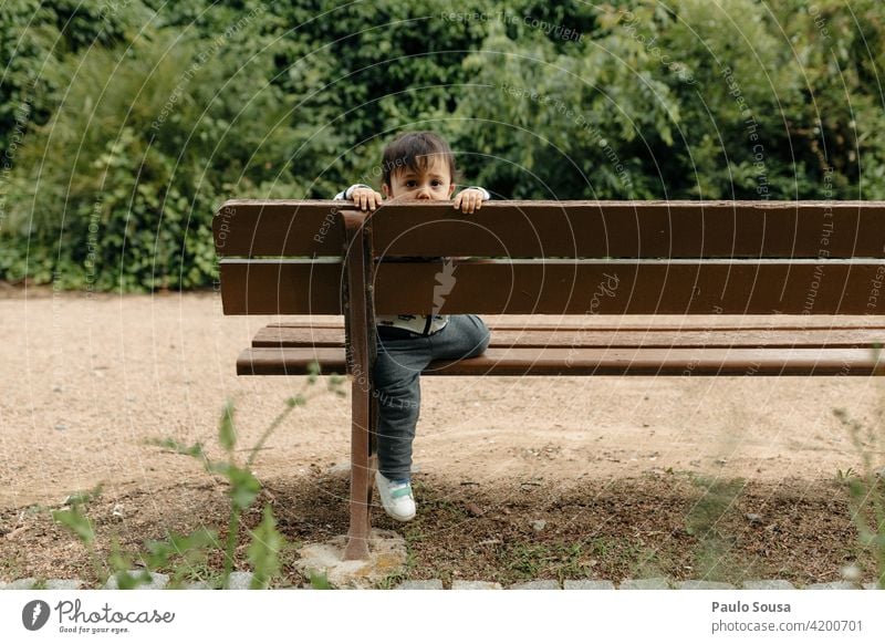 Child playing on garden bench 1 - 3 years Caucasian Bench Lifestyle Exterior shot Human being Colour photo Toddler Infancy Multicoloured Leisure and hobbies