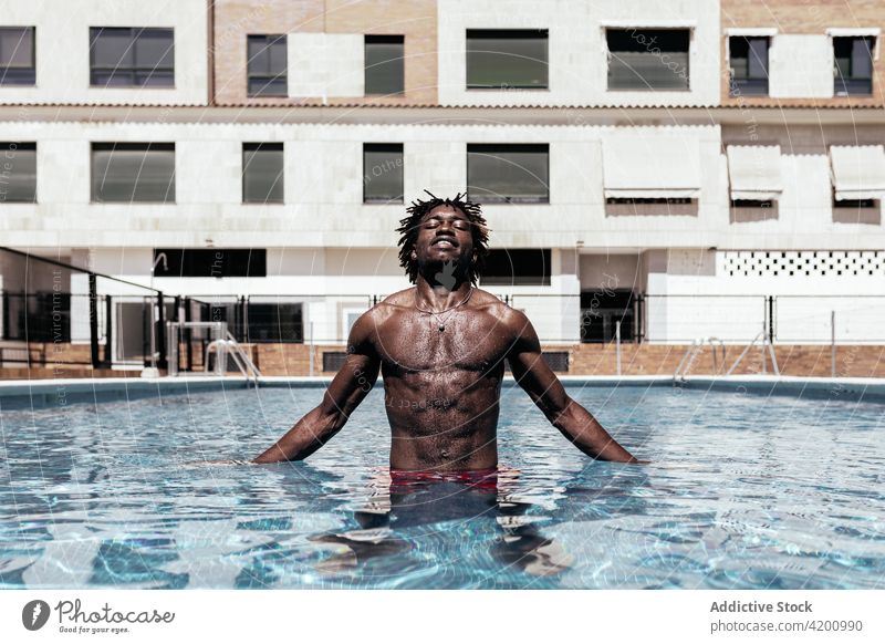 Black man in swimming pool - a Royalty Free Stock Photo from Photocase