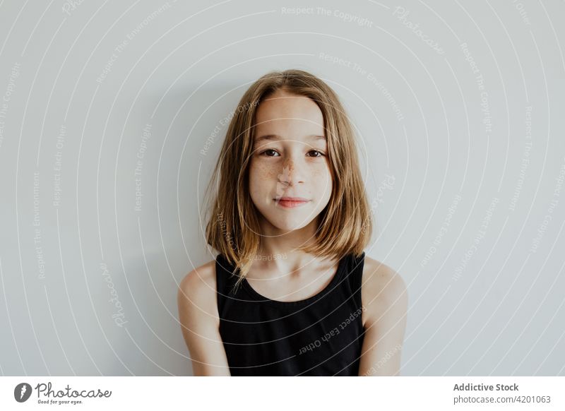 Pensive teen girl looking at camera against white background calm pensive tranquil style appearance portrait charismatic personality adorable child teenage cute