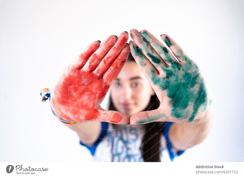 Painter showing dirty hands on white background painter messy perspective art triangle outstretch woman bright colorful red green artist palm vivid charming