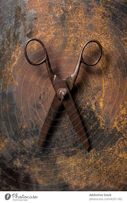 Old metal scissors on table rust old shabby weathered surface aged instrument tool grunge steel dark equipment metallic worn out desk iron manual corrosion