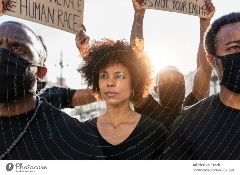 Crop black protesters with placards on strike in town sjw black lives matter human rights activism racism democracy movement woman mask covid 19 new normal blm