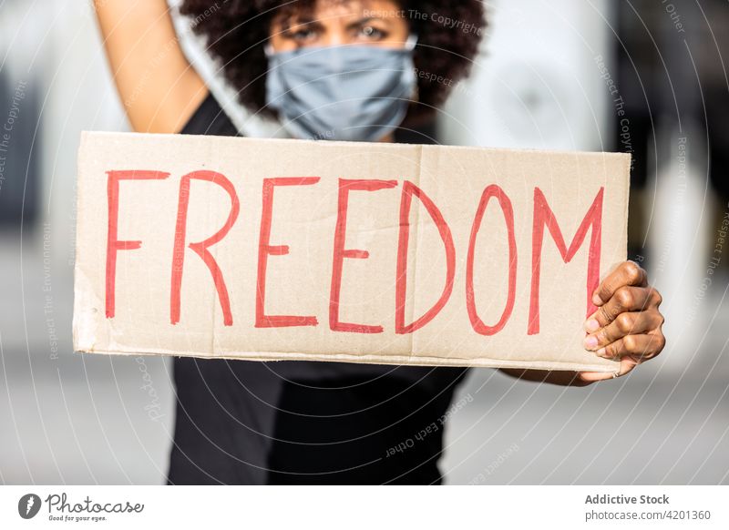 Crop black protester with Freedom inscription on placard on strike activist freedom blm social right racial equality movement woman street title sjw