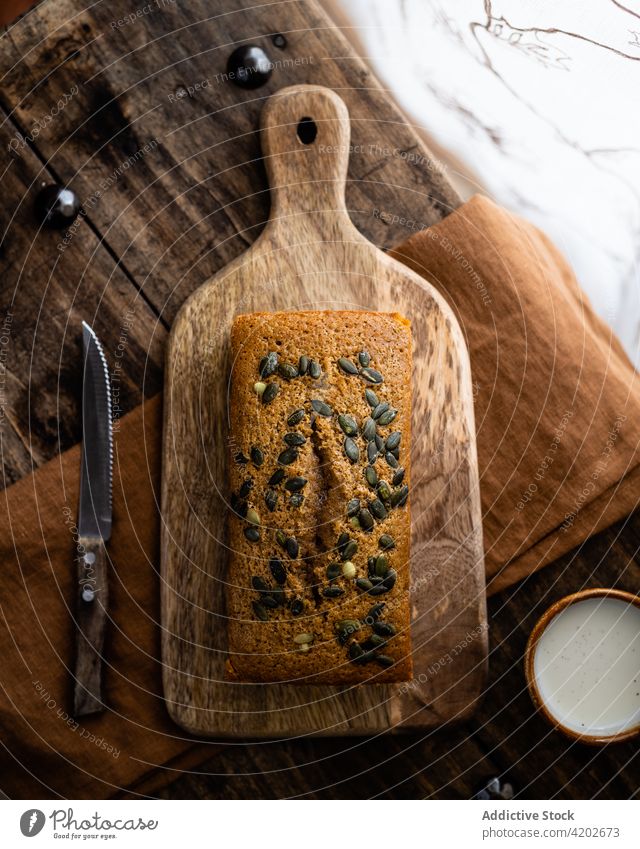 Yummy pumpkin loaf placed on cutting board bread grain baked wholesome appetizing wholegrain composition tasty pastry nutrition delicious culinary cuisine
