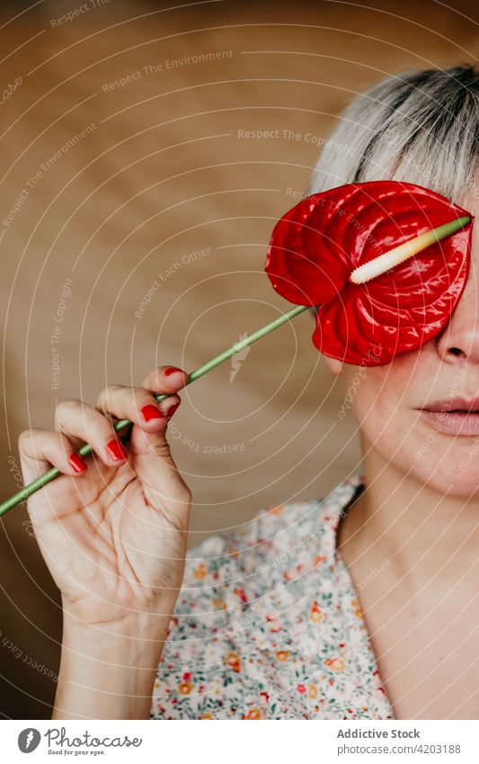 Crop woman covering face with anthurium red cover face flower plant cultivate stem flora blossom bloom botany horticulture lady casual organic natural manicure