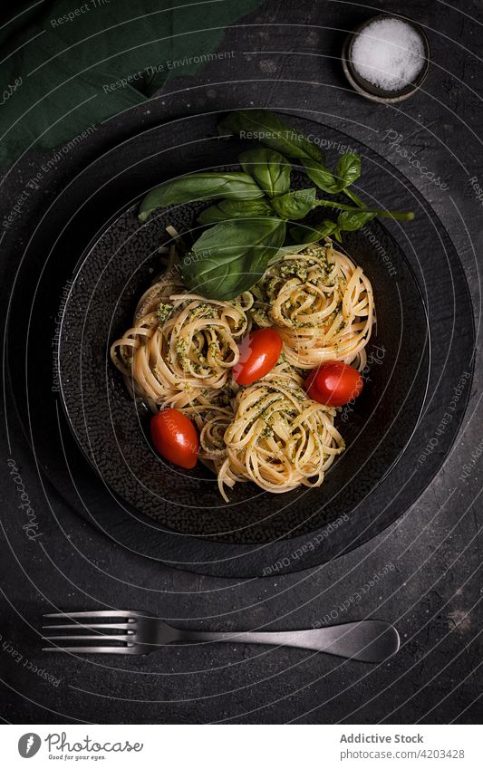 Delicious pasta with pesto sauce and tomatoes basil food tradition portion tagliatelle culinary cuisine meal palatable italian delicious plate tasty dish
