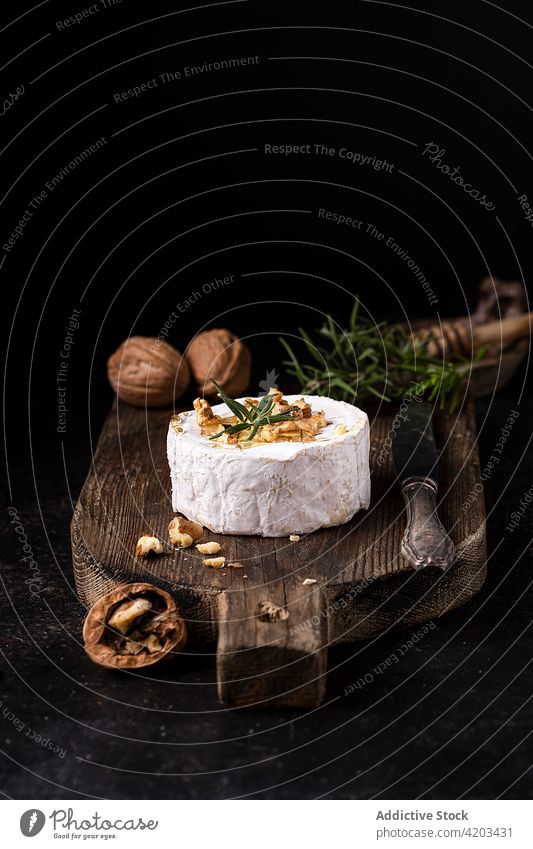 Camembert cheese with walnuts on wooden board camembert gourmet food fresh rosemary brie white whole culinary gastronomy tradition aromatic meal dairy rustic