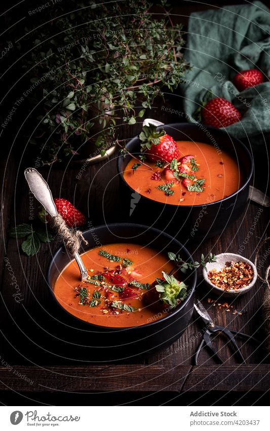 Bowls with tomato and strawberry soup on table bowl food gazpacho culinary red fresh natural spice vegetable recipe cuisine meal cold kitchen cook organic vegan