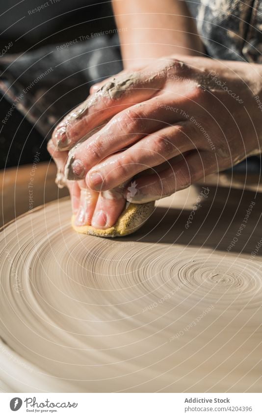 Crop ceramist creating clayware in workshop craftswoman pottery wheel create earthenware handmade ceramic handicraft female artisan tableware hobby skill master