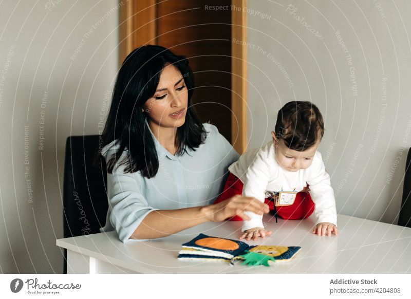 Young mother and little son reading childrens book together family parenthood positive mom motherhood childcare development upbringing adorable cute fairytale