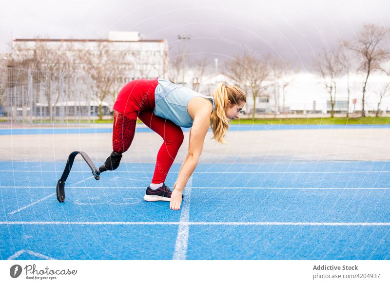 Sportswoman with bionic leg prosthesis at stadium sportswoman run runner paralympic athlete training energy sprinter female professional racetrack artificial