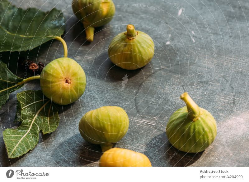 Ripe sweet green figs, freshly harvested from domestic tree, on table with grunge texture. fruit ripe organic food diet nature healthy juicy raw freshness