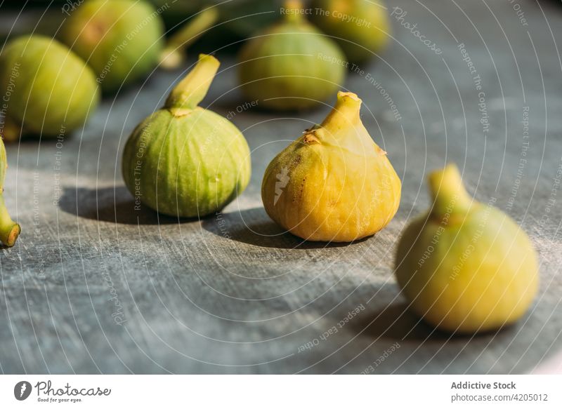 Ripe sweet green figs, freshly harvested from domestic tree, on table with grunge texture. fruit ripe organic food diet nature healthy juicy raw freshness