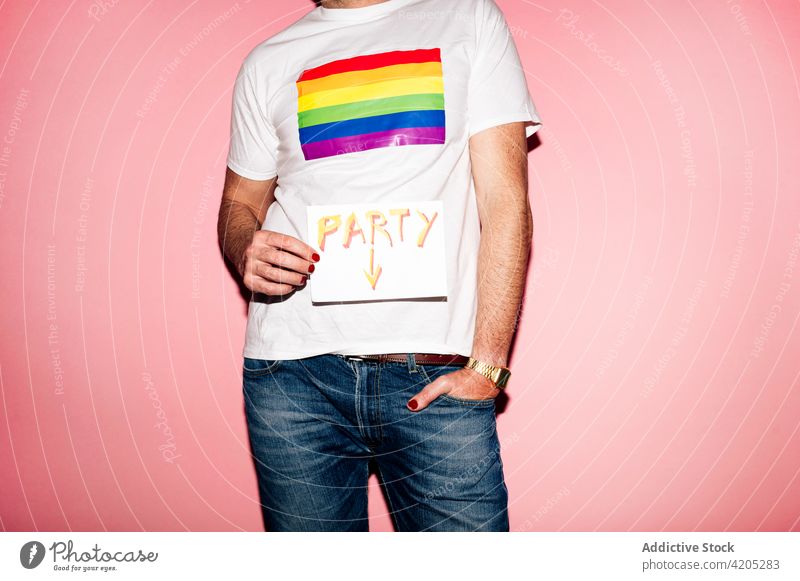Faceless gay showing placard with Party text man lgbt party homosexual equal tolerance inscription solidarity concept flag pride male t shirt rainbow manicure