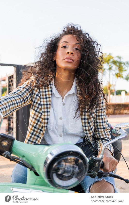 Thoughtful ethnic woman on vintage scooter wistful transport street dreamy city urban ponder thoughtful female black african american young summer sunny modern