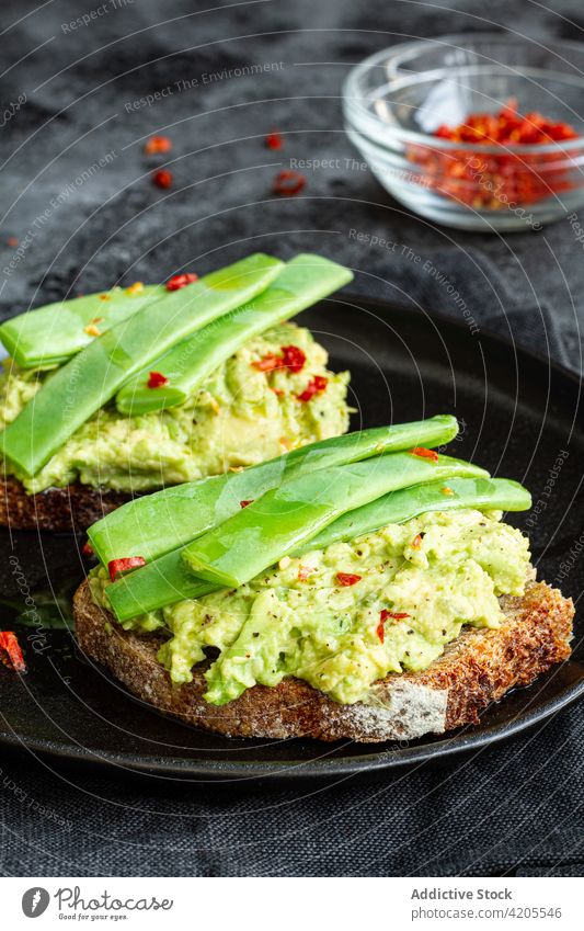 Delicious toasts with guacamole and green pea pods delicious tasty serve appetizing yummy eat vegetarian meal organic cuisine nutrition vegetable fresh dish