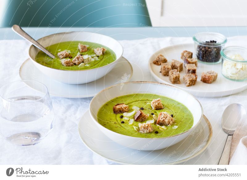 Bowls with tasty zucchini cream soup on table serve bowl crouton meal food lunch dish home portion delicious palatable delectable cuisine fresh organic