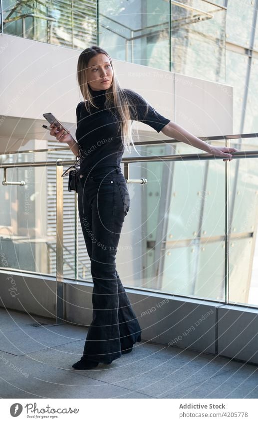 Woman using her smartphone woman Russian girl alone beautiful blond city city life cityscape day downtown elegant female formal long hair millenial model
