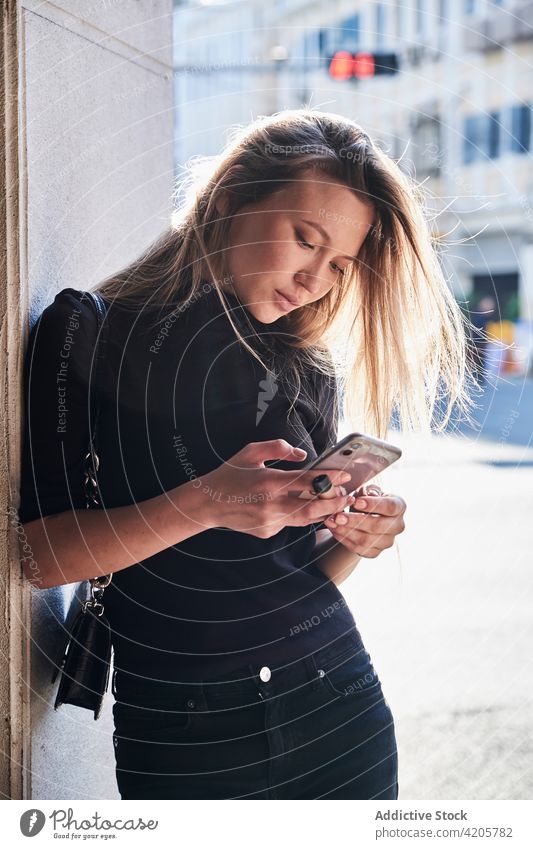 Woman using her smartphone woman Russian girl alone beautiful blond city city life cityscape day downtown elegant female formal long hair millenial model