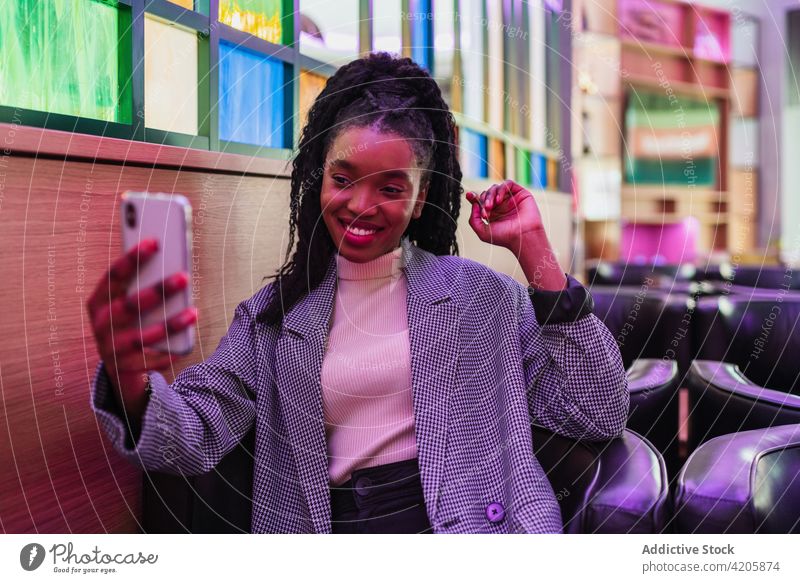 Confident young ethnic woman taking selfie on smartphone in cafe confident smile style fashion joy optimist positive happy female african american black trendy