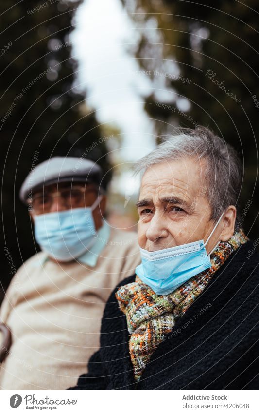 Elderly couple with face mask on the street man woman elderly outdoor female adult epidemic coronavirus health love old covid-19 married mature grandfather