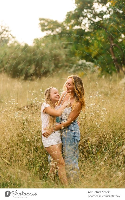 Woman embracing little sister in field siblings relationship tender teenage girl together hug meadow summer love embrace happy bonding cuddle delicate gentle