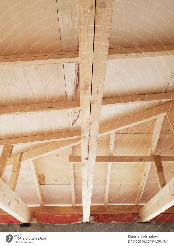view of wooden rafters when installing roof on construction of house ceiling frame beam interior timber building beams plank estate inside architecture