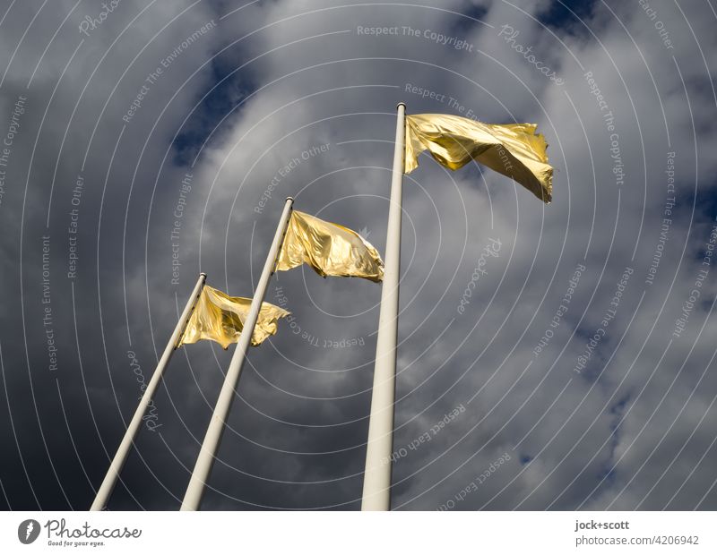 golden flag flutters in the wind Flagpole Sky Clouds Wind Blow Judder Gold Sunlight Street art three dark background Worm's-eye view
