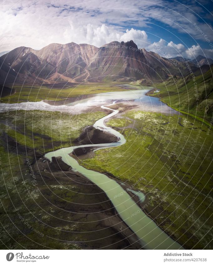 Scenic river loop in grassy hilly valley nature lush terrain highland majestic curvy picturesque iceland scenic wonderful peaceful stream flow verdant creek