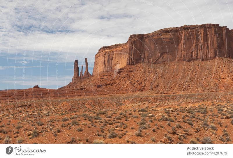Monument alley in desert terrain monument valley national park rocky formation canyon nature pole landscape cloudy scenery usa united states america sightseeing