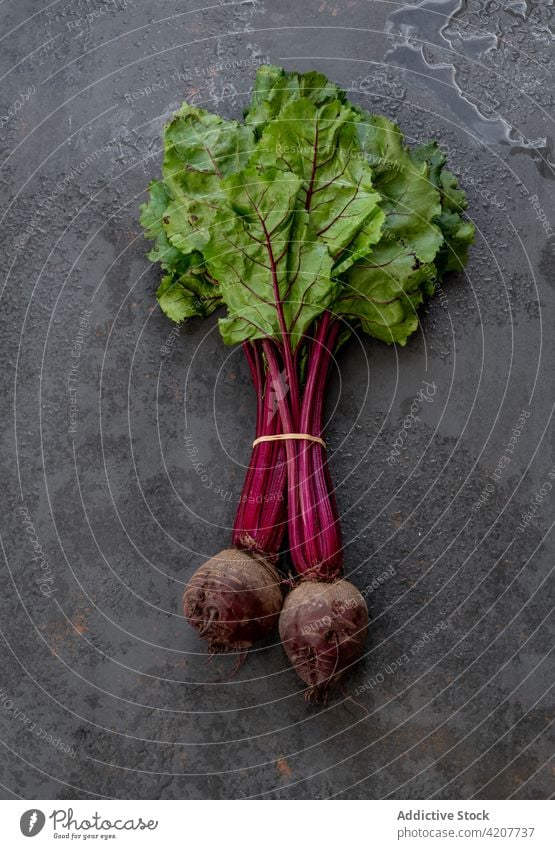 Bunch of fresh beet on black table bunch vegetable ripe harvest vitamin food healthy organic natural edible nutrition shabby weathered grunge vegetarian raw