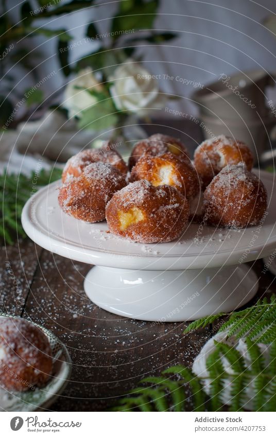 Homemade custard cream fritters on wooden table food dessert delicious cuisine snack sweet pastry tasty fried gourmet sugar dough dish leafs culinary doughnut