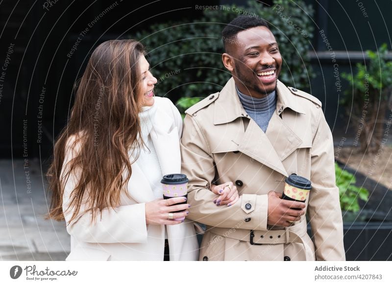 Happy multiethnic couple in stylish clothes with takeaway coffee style happy cup urban together fashion relationship romantic love cheerful multiracial diverse