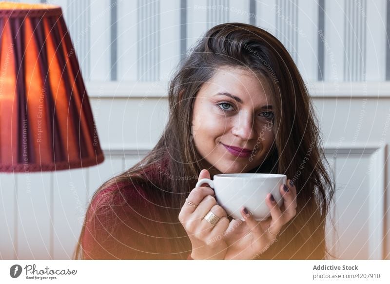 Woman with cup of coffee in cafe woman dream window smile pensive happy drink charming dreamy female adult beverage relax free time lifestyle rest enjoy