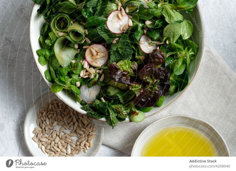 Bowl with healthy salad on table vegetable lunch food bowl fresh organic natural serve olive oil sunflower seed meal tasty appetizing yummy nutrition