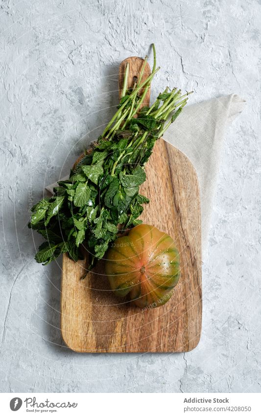 Fresh tomato and mint on wooden board fresh vegetable food natural cutting board organic stripe prepare healthy meal ingredient vitamin culinary nutrition